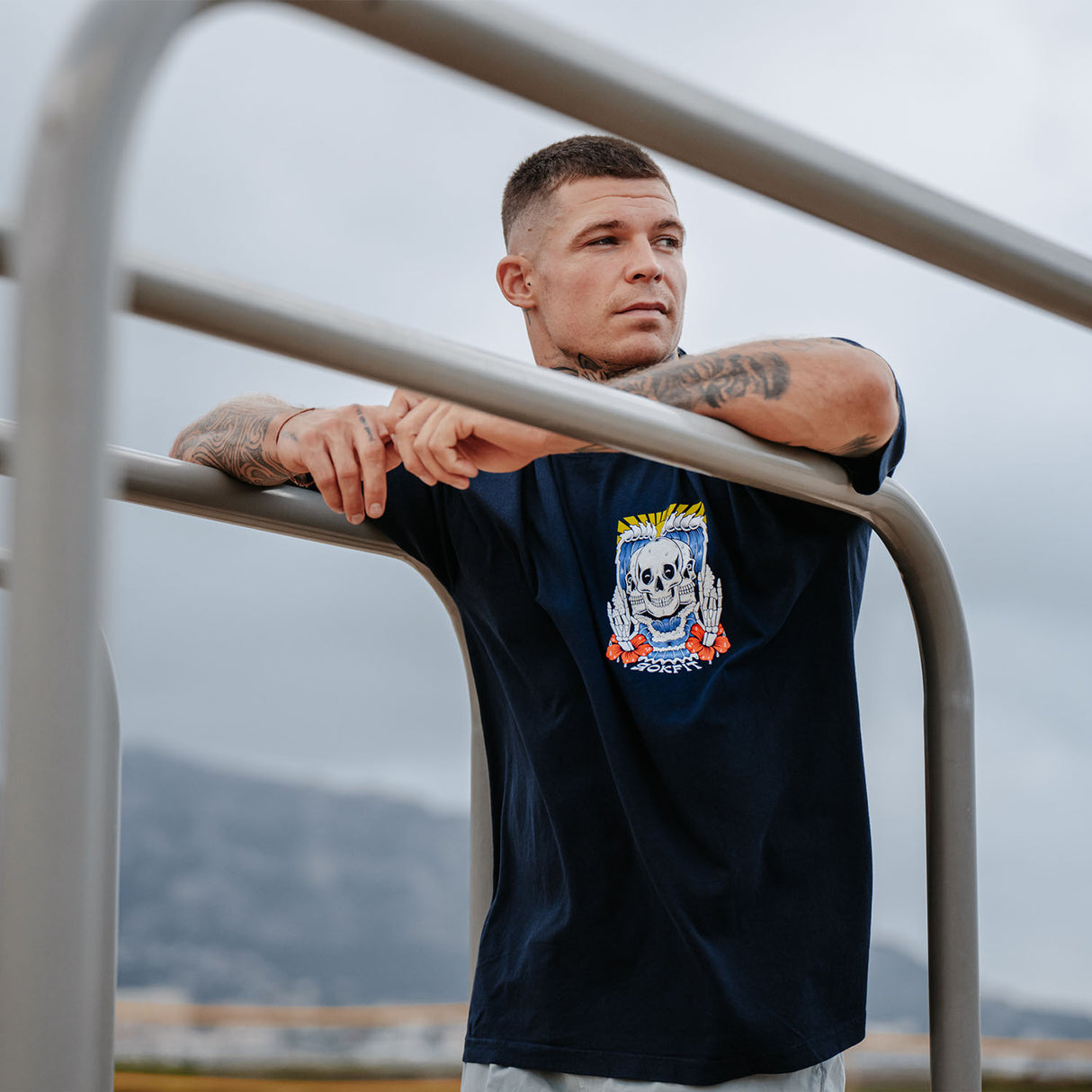 Male model outdoors wearing unisex Street Tee with 'Discipline Weighs Ounces' graphic