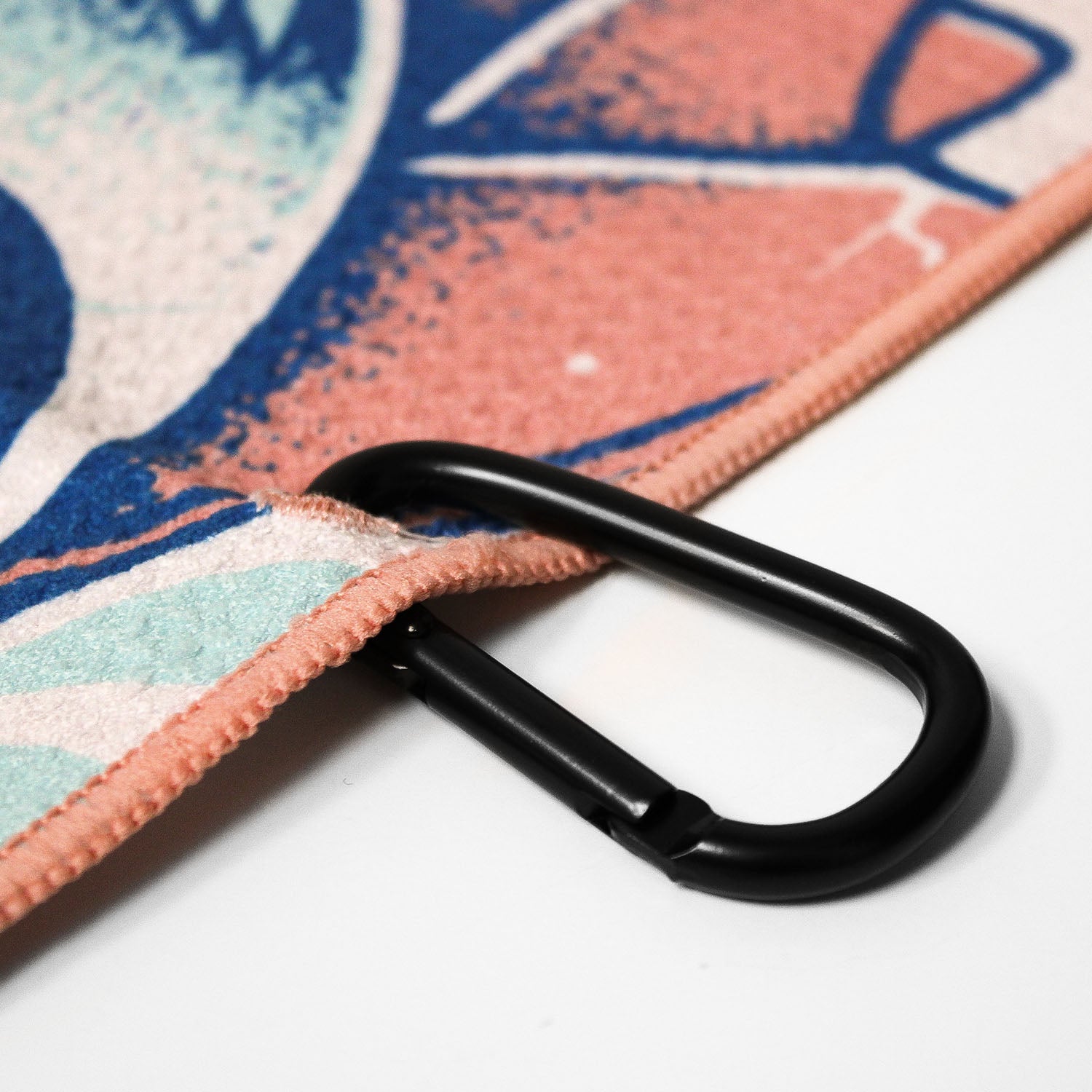 Close up of Utility Towel black carabiner clip with 'Endless Summer' graphic