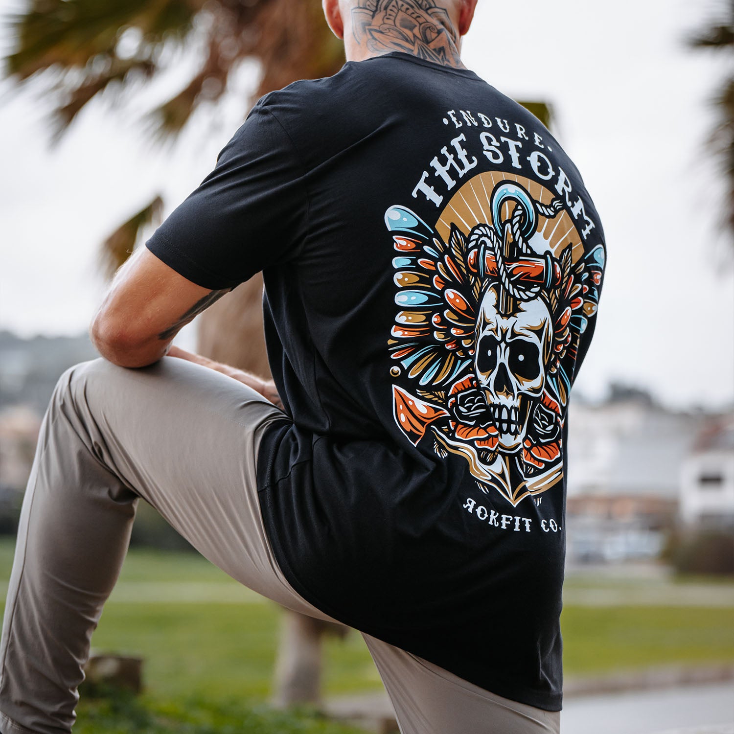 Male model outdoors wearing unisex Active Tee with 'Endure The Storm' graphic