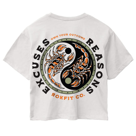 Back view of women's white crop top with 'Excuses or Reasons' graphic