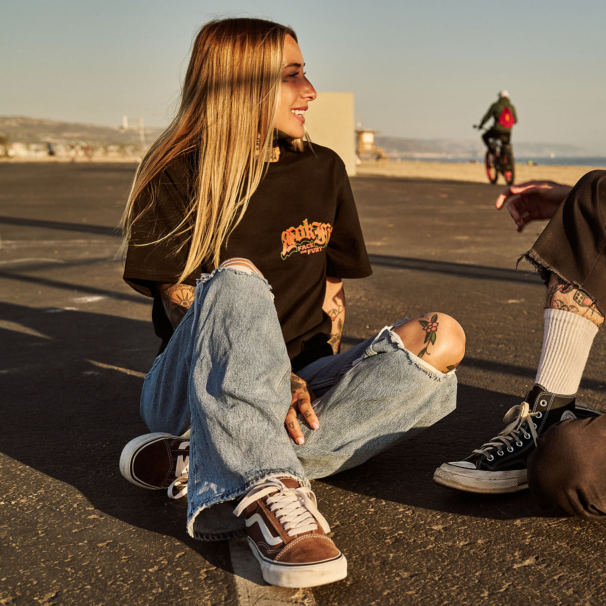 Female model outdoors wearing a unisex Street Tee with 'Face The Fury' graphic