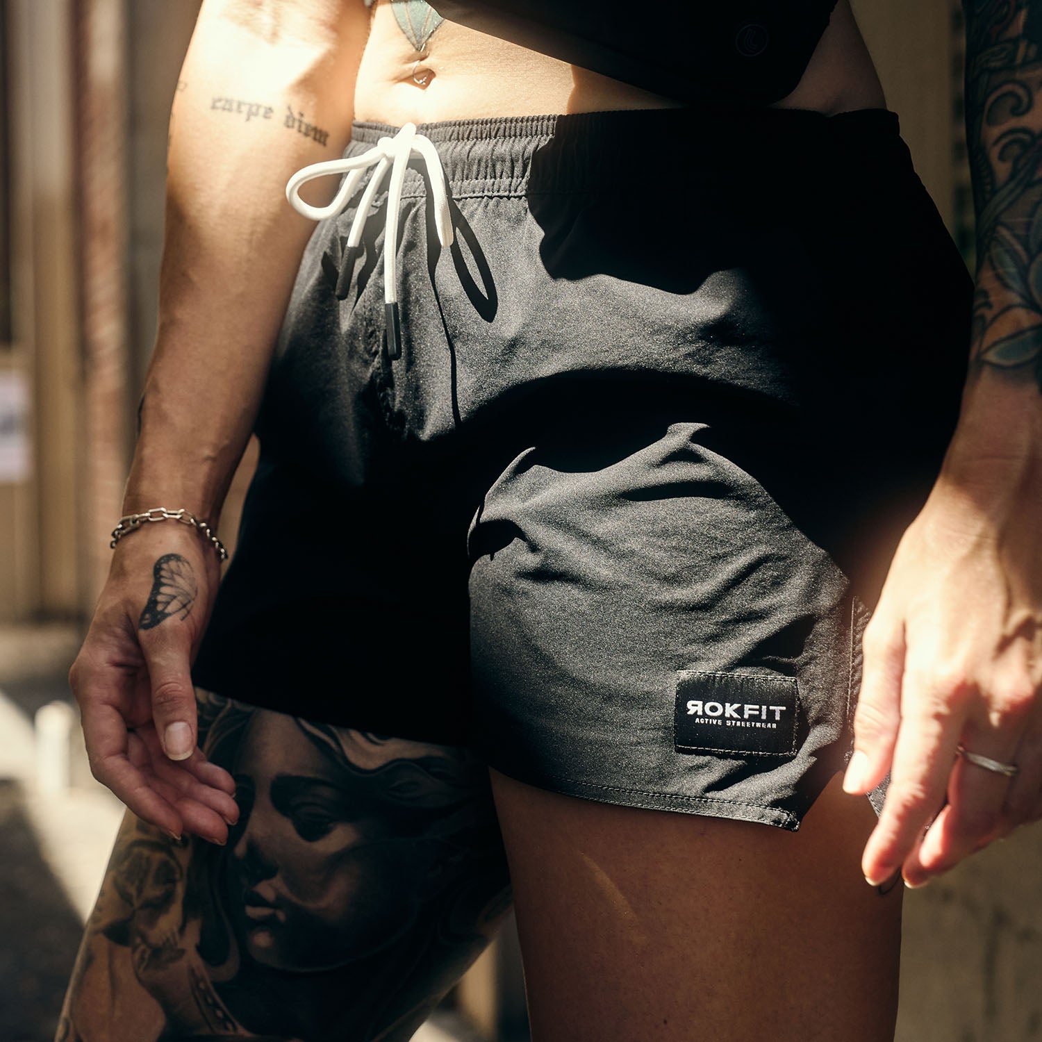 Female model outdoors wearing women's black Hybrid Shorts
