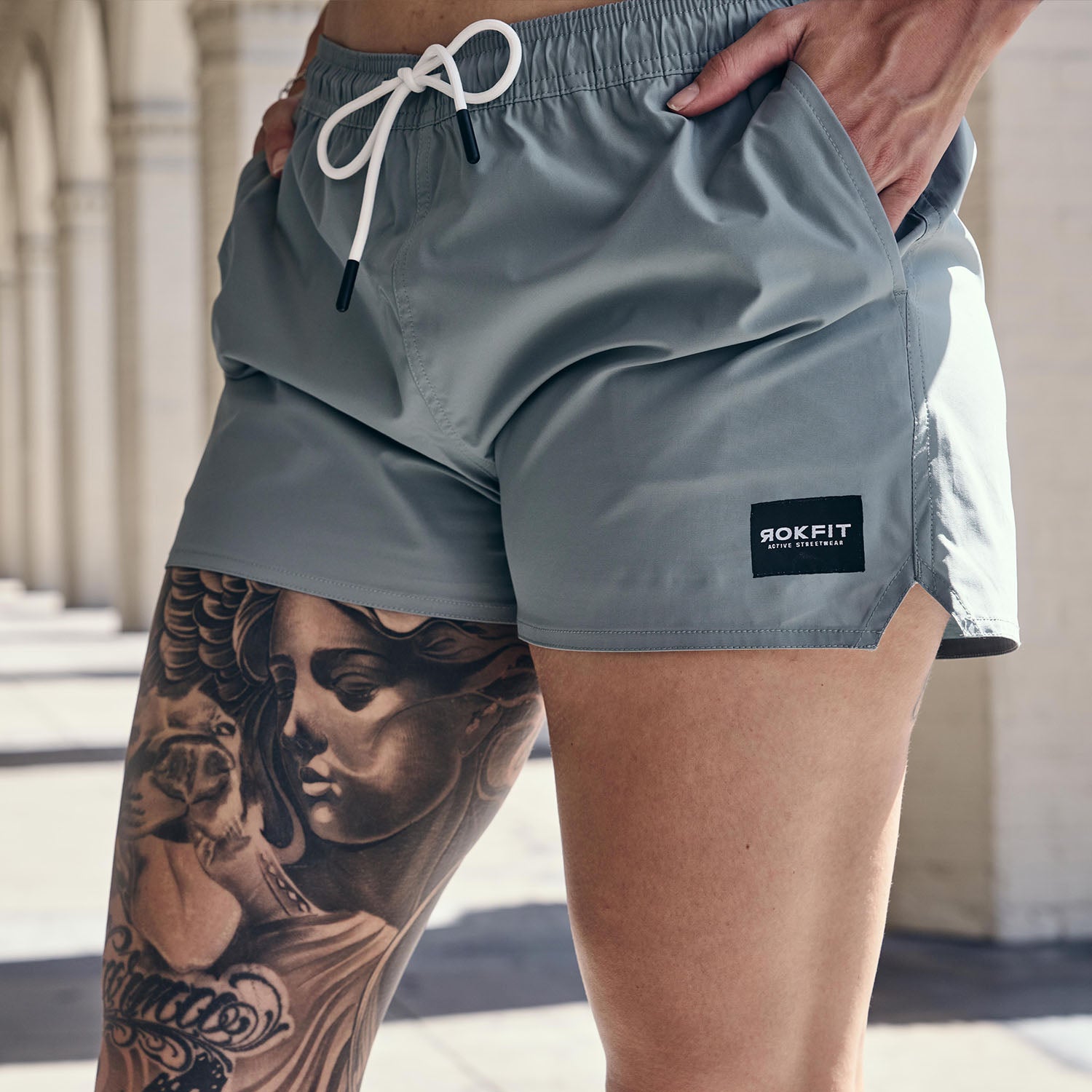Female model outdoors wearing women's sage Hybrid Shorts