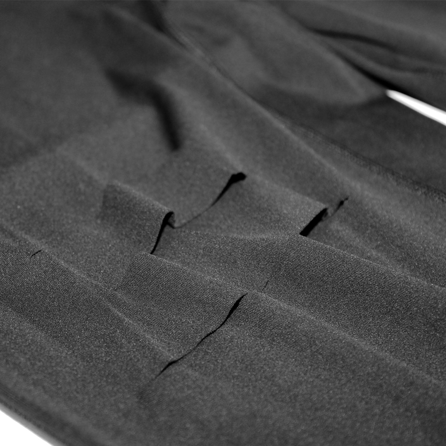 Front view of women's black Cutline Leggings showing close up of laser cuts