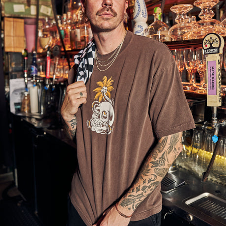 Male model showing Utility Towel draped over shoulder in bar with 'Checker' graphic